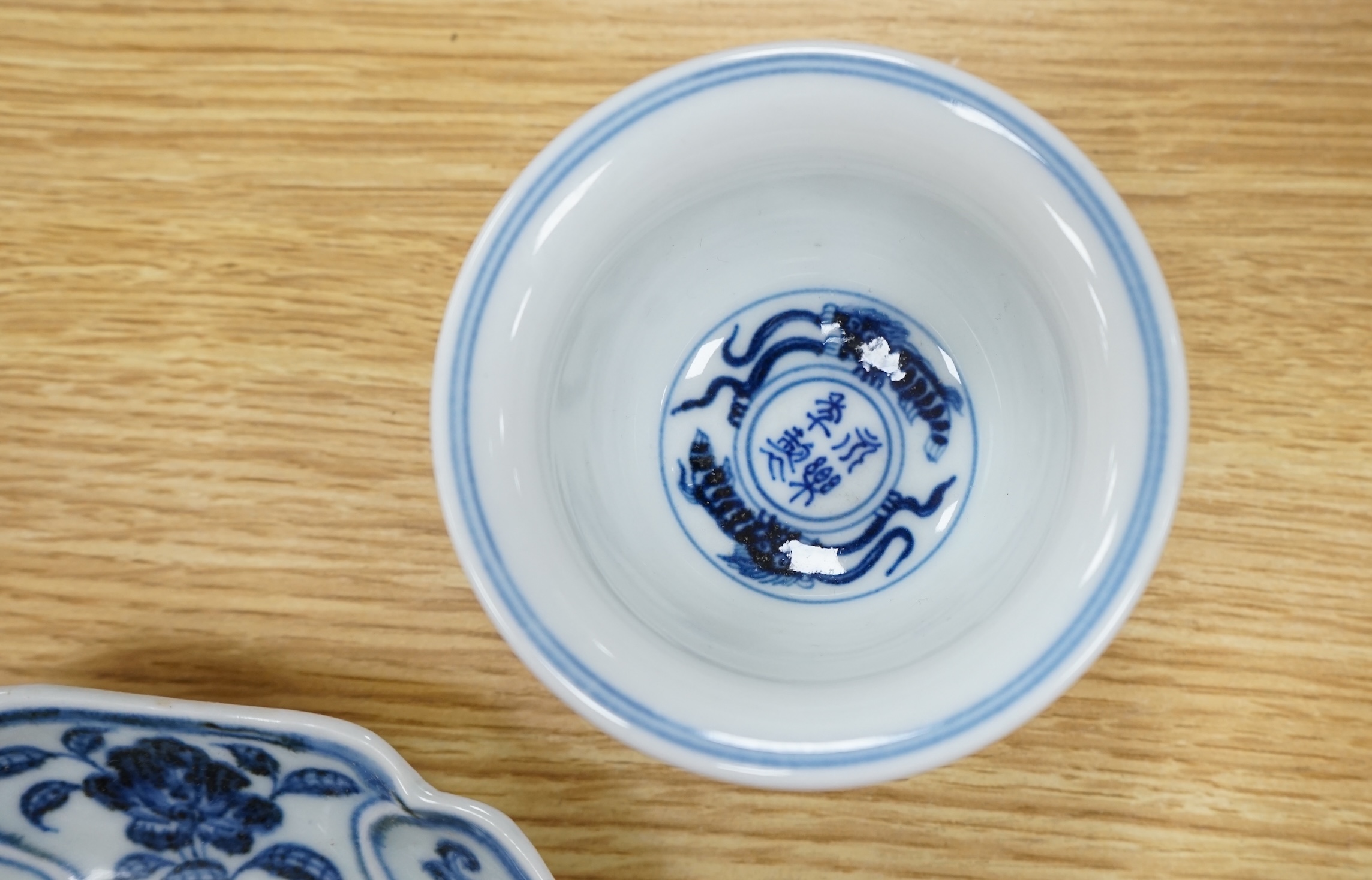 A Chinese copper red glazed dish, a blue and white bowl and a similar dish, bowl 22.5cm diameter. Condition - good